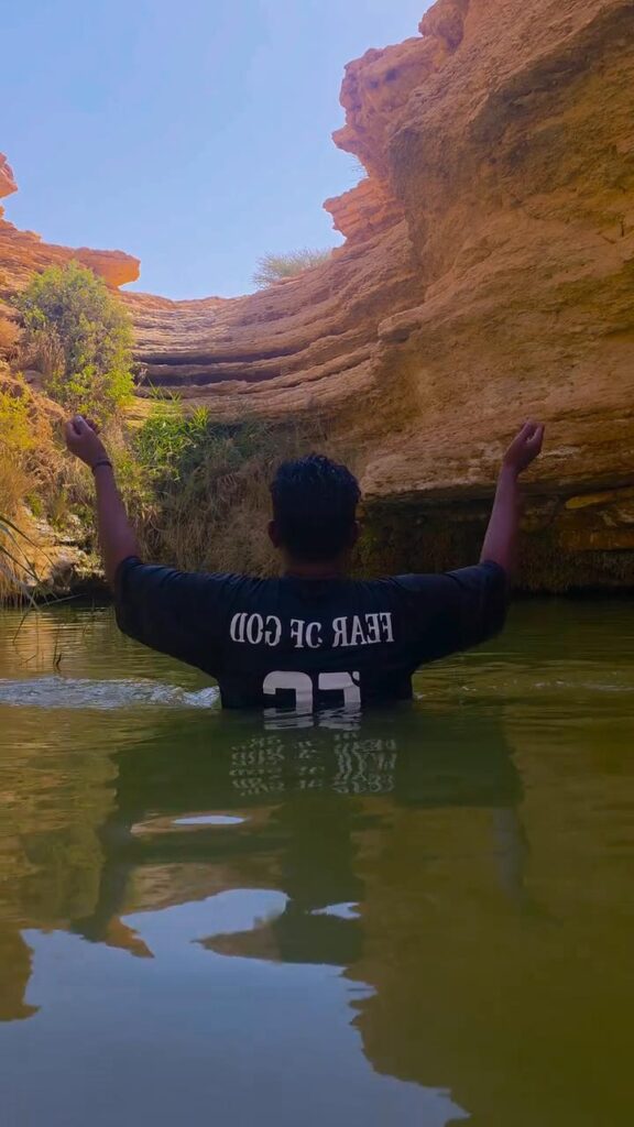 Family picnic and relaxation at a natural pool near Riyadh