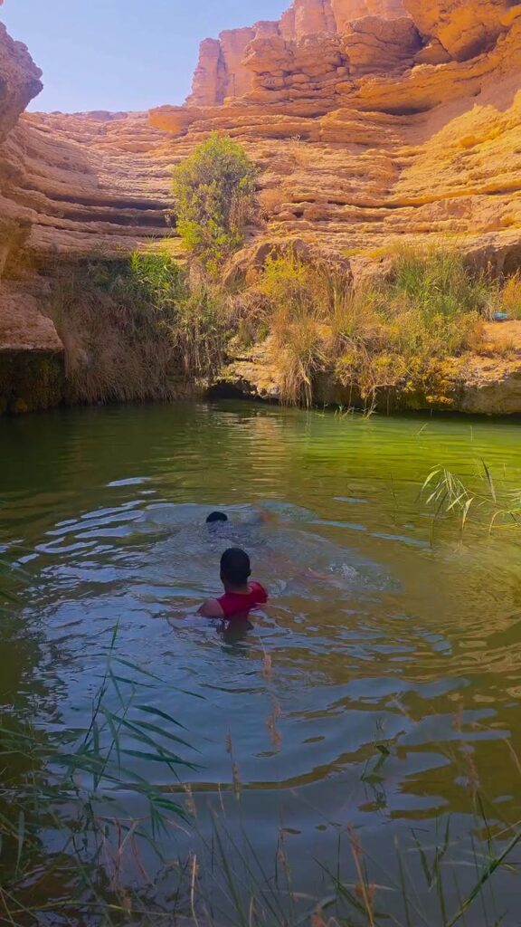 Friends enjoying a swim at a natural pool near Riyadh